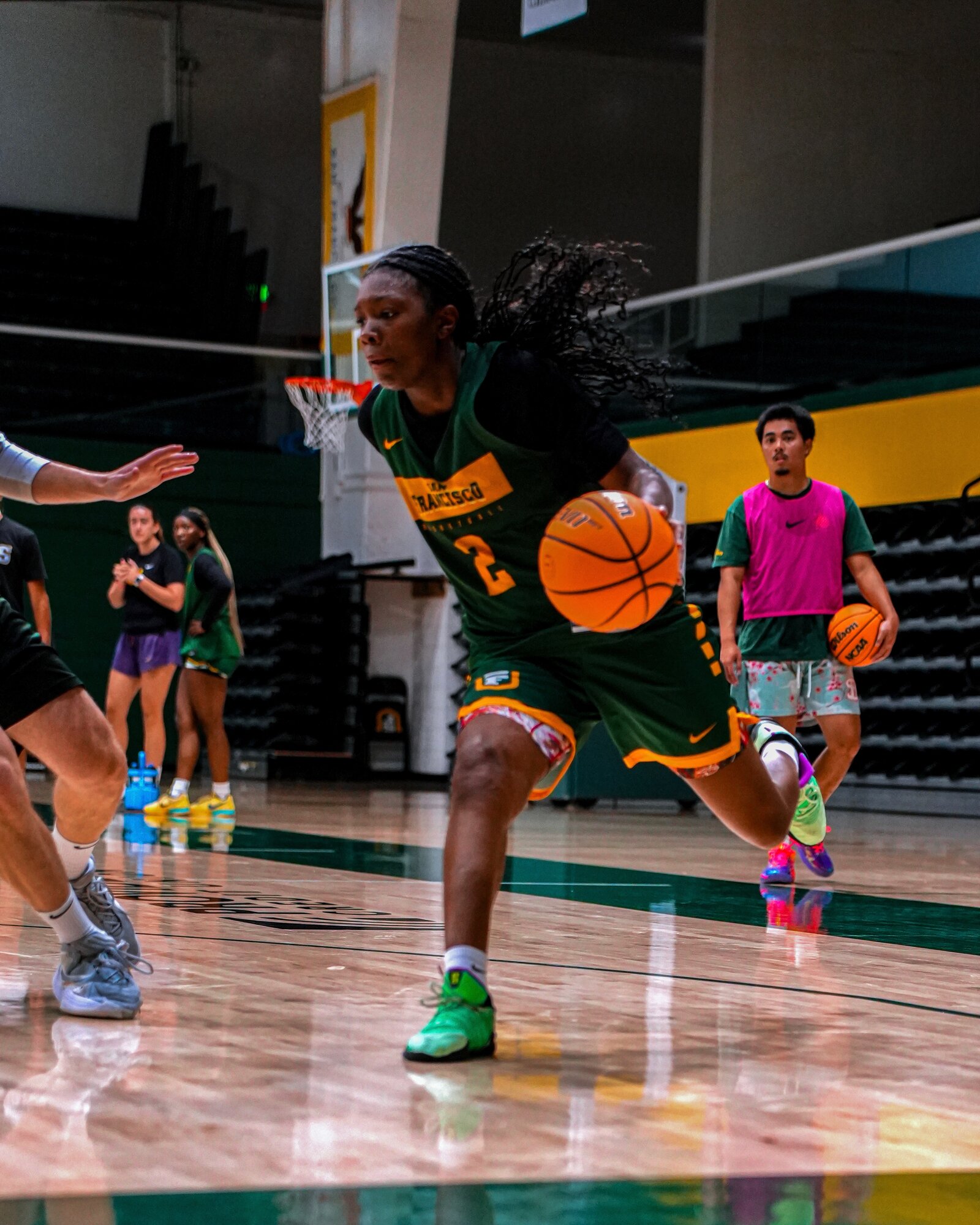USF Dons forward attacking off the dribble, hair flying