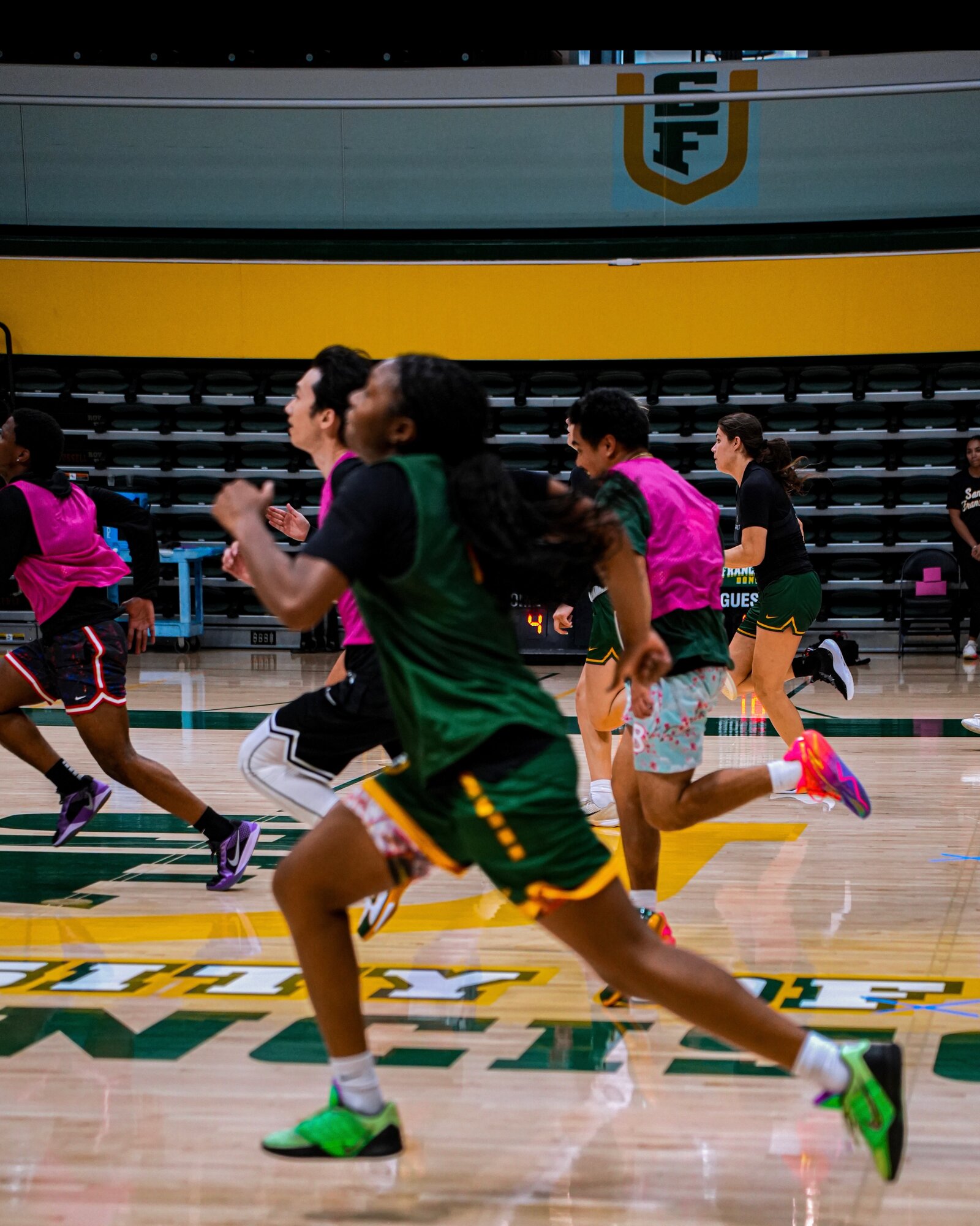 USF Dons sprint drill, pink and green pinnies at full speed